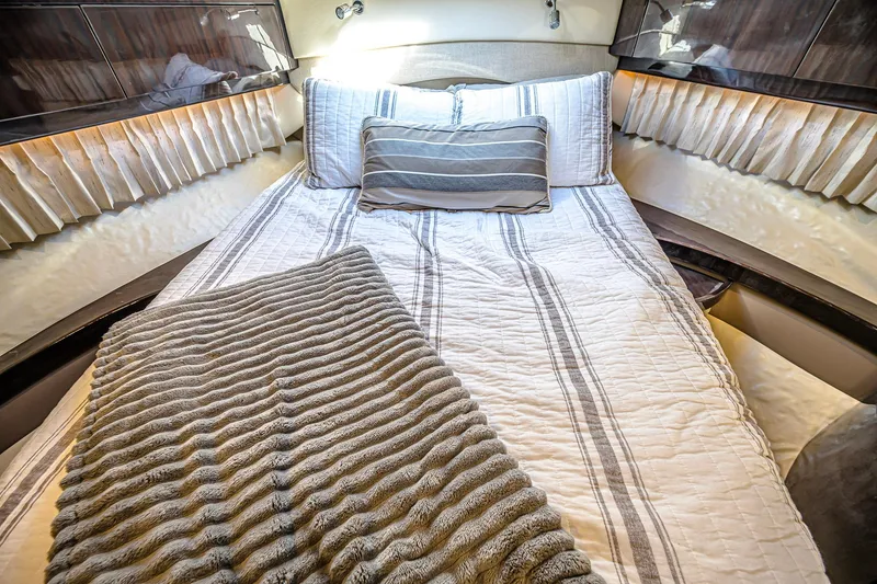 Slide: The Image of Luxurious bedroom interior of 2016 Regal 46 Sport Coupe yacht with striped bedding. - 34