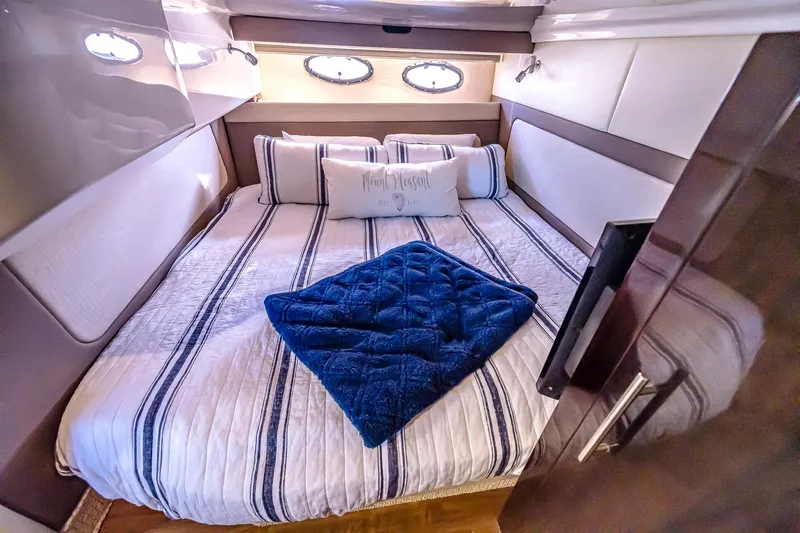 Slide: The Image of Luxurious bedroom interior of 2016 Regal 46 Sport Coupe yacht with striped bedding. - 36