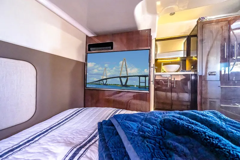 Slide: The Image of Interior of 2016 Regal 46 Sport Coupe with cozy bed and modern amenities. - 39