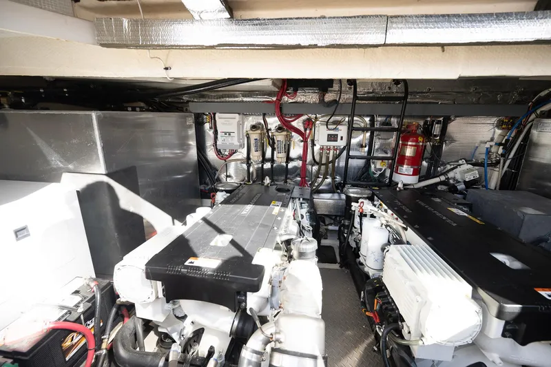 Slide: The Image of Engine room of 2016 Regal 46 Sport Coupe with dual engines and fire extinguisher. - 46