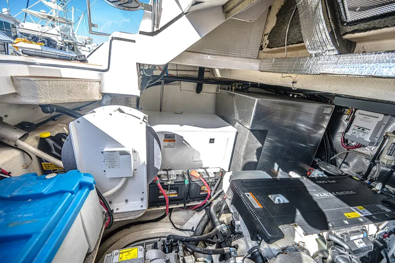 Slide: The Image of Engine room of 2016 Regal 46 Sport Coupe with visible components and wiring. - 47