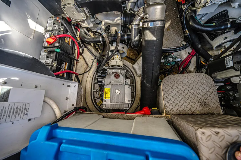 Slide: The Image of Engine room of 2016 Regal 46 Sport Coupe with visible batteries and mechanical components. - 48