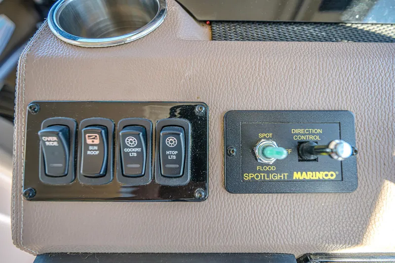 Slide: The Image of Control panel of a 2016 Regal 46 Sport Coupe with switches and spotlight controls. - 56