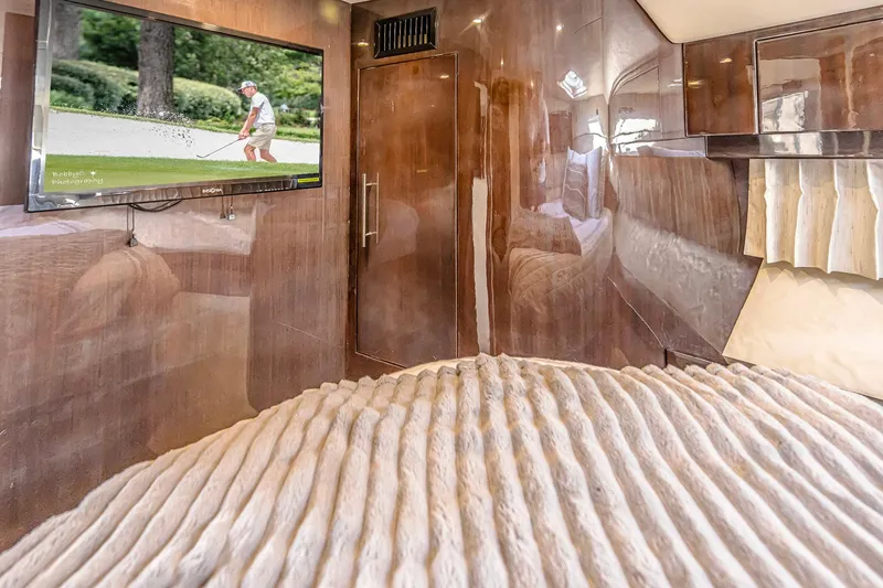 Slide: The Image of Luxurious interior of 2016 Regal 46 Sport Coupe with TV and plush bedding. - 58