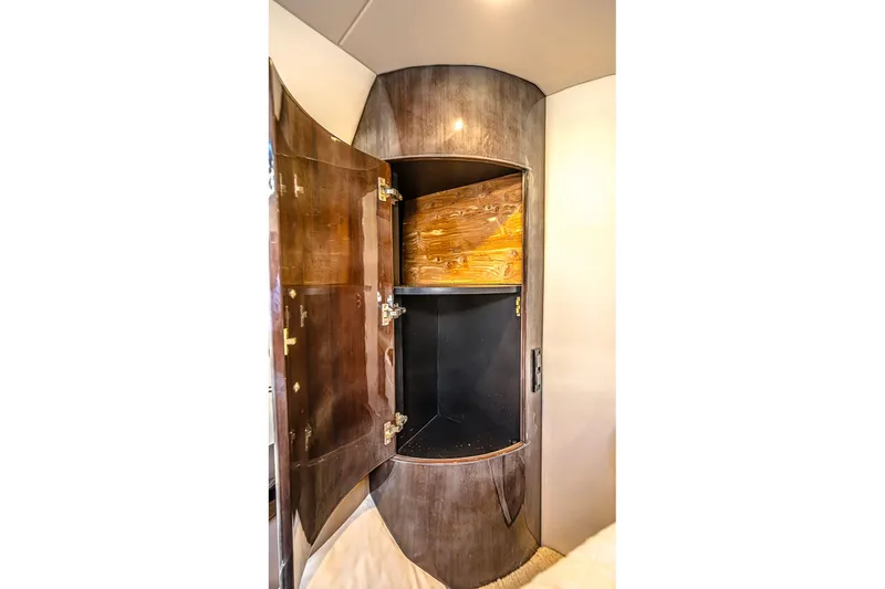 Slide: The Image of Open wooden cabinet inside 2016 Regal 46 Sport Coupe yacht interior. - 60