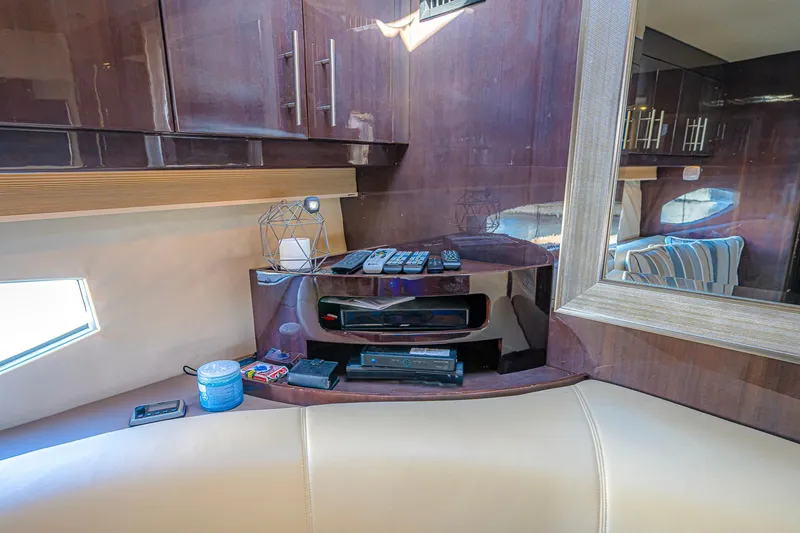 Slide: The Image of Interior of 2016 Regal 46 Sport Coupe with modern cabinetry and entertainment setup. - 66