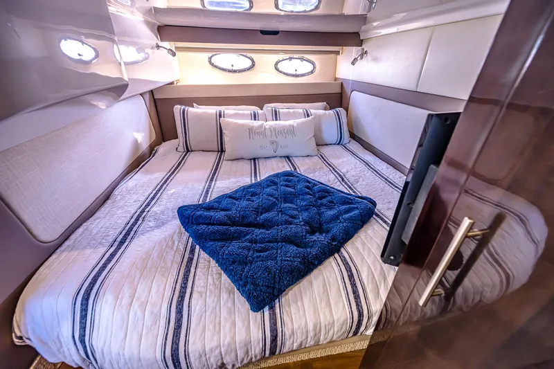 Slide: The Image of Luxurious cabin interior of 2016 Regal 46 Sport Coupe with cozy bedding. - 68