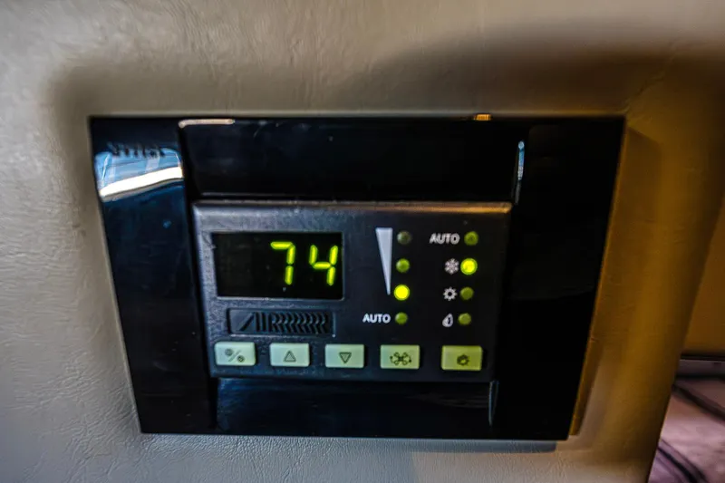 Slide: The Image of Thermostat control panel in 2016 Regal 46 Sport Coupe displaying 74 degrees. - 69