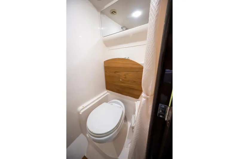 Slide: The Image of 2016 Regal 46 Sport Coupe bathroom with modern fixtures and wooden accents. - 70