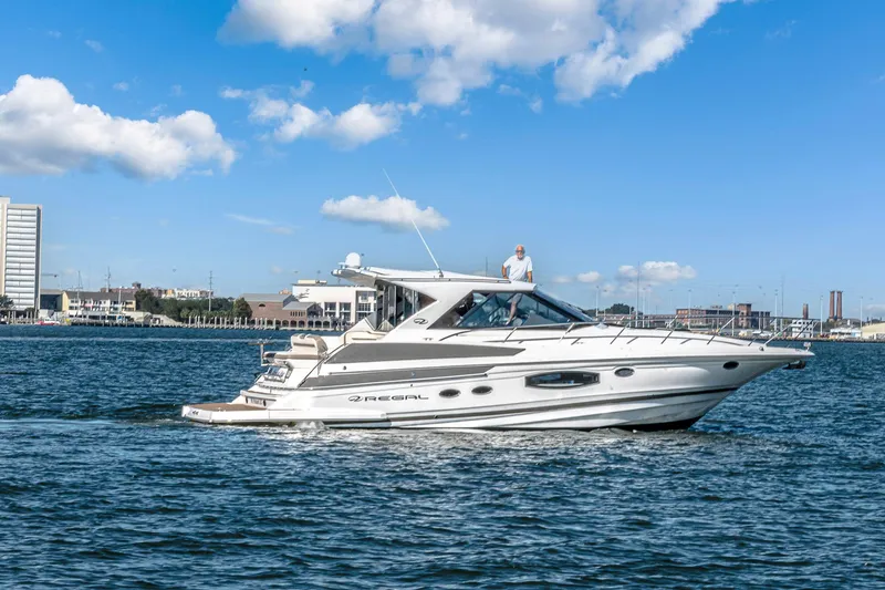 Slide: The Image of 2016 Regal 46 Sport Coupe yacht cruising on a sunny day. - 74