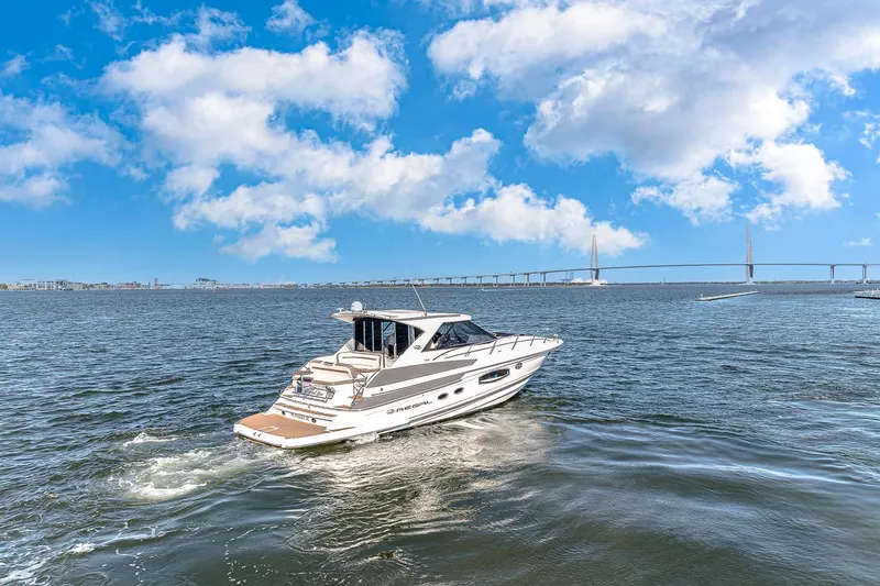 Slide: The Image of 2016 Regal 46 Sport Coupe cruising on open water under a blue sky. - 75