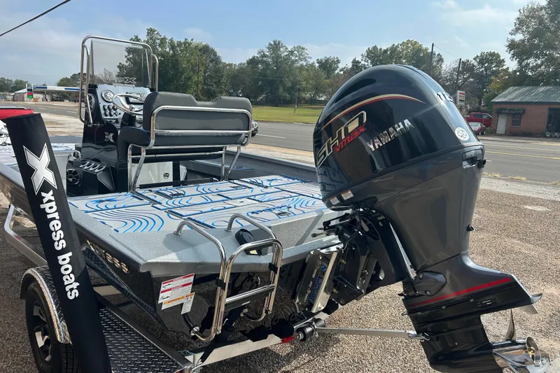 Slide: The Image of 2026 Xpress H20B Bay boat with Yamaha engine, parked outdoors. - 5