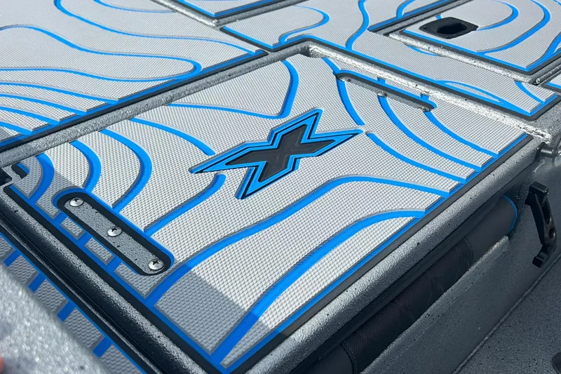 Slide: The Image of 2026 Xpress H20B Bay boat deck with blue wave patterns and logo. - 6