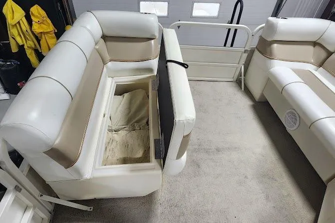 Slide: The Image of 2006 Bentley Pontoons 200/203 Cruise interior with open storage compartment and beige seating. - 10