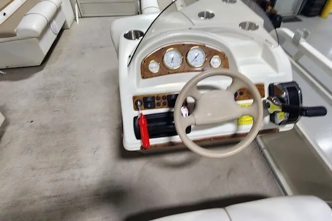 Slide: The Image of 2006 Bentley Pontoons 200/203 Cruise dashboard with steering wheel and control panel. - 13