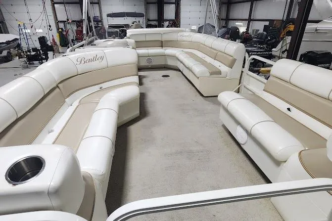 Slide: The Image of 2006 Bentley Pontoons 200/203 Cruise interior with spacious seating in a storage facility. - 6