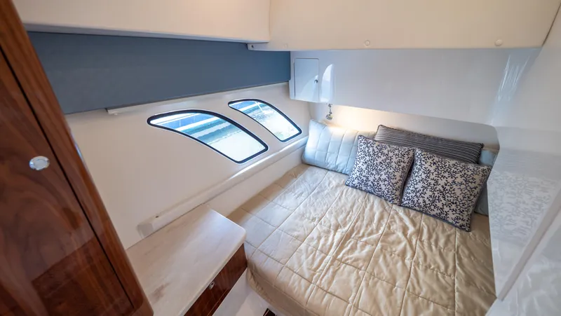 Slide: The Image of Luxurious cabin interior of 2018 Intrepid 430 Sport Yacht with cozy bed and elegant decor. - 12