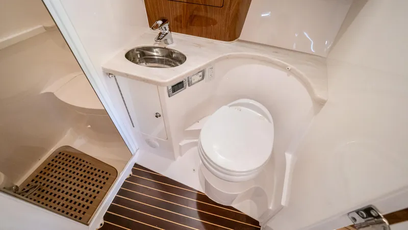 Slide: The Image of Luxurious bathroom in 2018 Intrepid 430 Sport Yacht with modern fixtures and wood accents. - 13