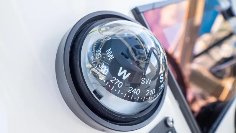 Slide: The Image of Close-up of a compass on a 2018 Intrepid 430 Sport Yacht dashboard. - 18