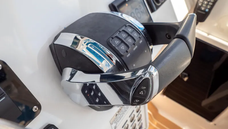 Slide: The Image of Close-up of 2018 Intrepid 430 Sport Yacht throttle control with chrome accents. - 19