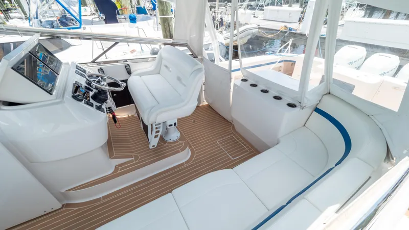 Slide: The Image of 2018 Intrepid 430 Sport Yacht cockpit with white seating and modern helm controls. - 2