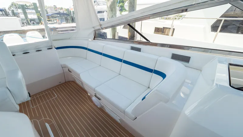 Slide: The Image of 2018 Intrepid 430 Sport Yacht interior with white seating and wood flooring. - 3