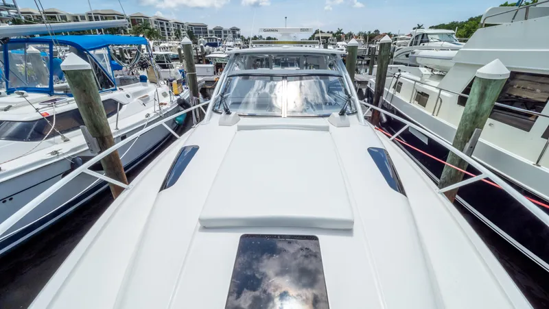 Slide: The Image of 2018 Intrepid 430 Sport Yacht docked among other boats at a marina. - 30