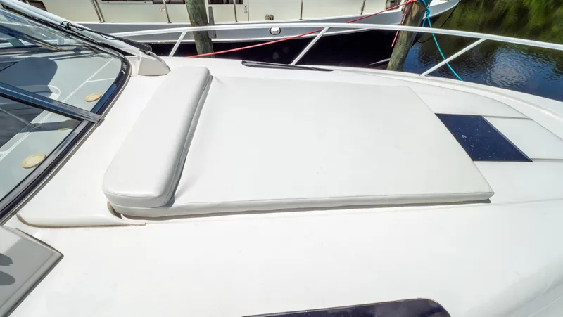 Slide: The Image of 2018 Intrepid 430 Sport Yacht sunpad on deck, featuring sleek design and comfortable seating. - 4