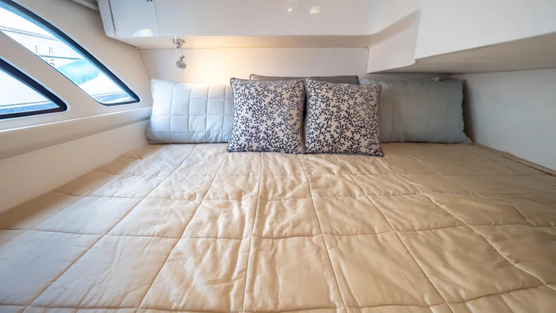 Slide: The Image of Cozy cabin interior of 2018 Intrepid 430 Sport Yacht with plush bedding and decorative pillows. - 41