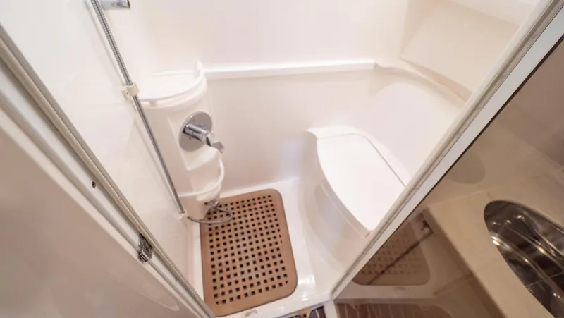 Slide: The Image of 2018 Intrepid 430 Sport Yacht bathroom with shower and wooden floor mat. - 42