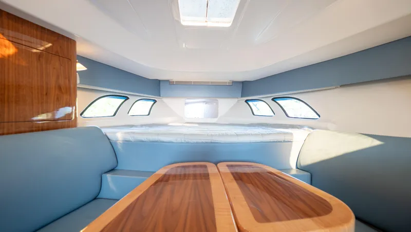 Slide: The Image of Interior of 2018 Intrepid 430 Sport Yacht with elegant wood table and plush seating. - 44