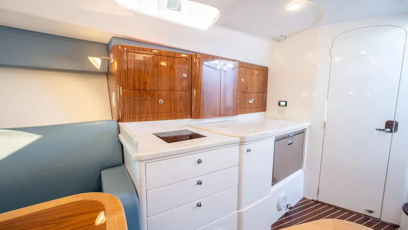 Slide: The Image of 2018 Intrepid 430 Sport Yacht interior with sleek cabinetry and modern kitchen amenities. - 48