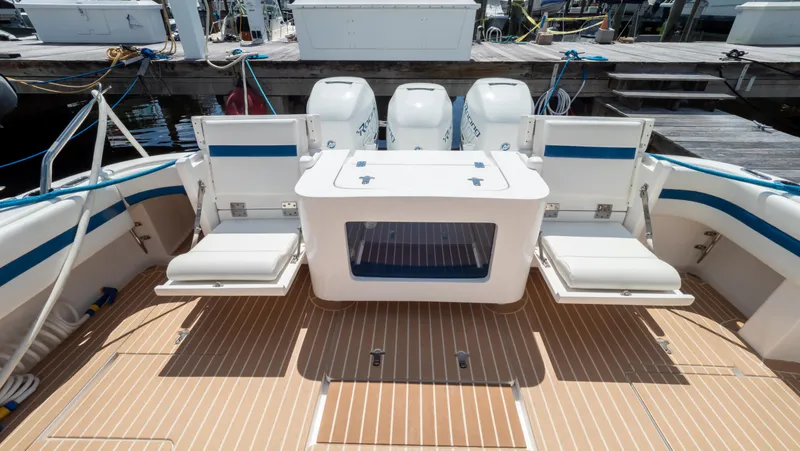 Slide: The Image of 2018 Intrepid 430 Sport Yacht deck with seating and outboard motors. - 5