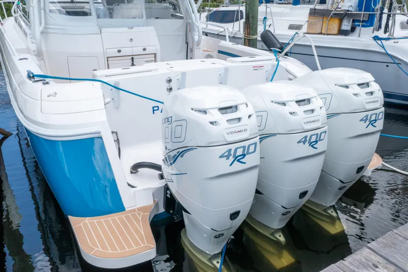 Slide: The Image of 2018 Intrepid 430 Sport Yacht with triple 400R outboard engines docked at marina. - 7