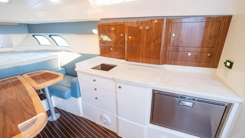 Slide: The Image of Luxurious interior of 2018 Intrepid 430 Sport Yacht with modern kitchen and seating area. - 9