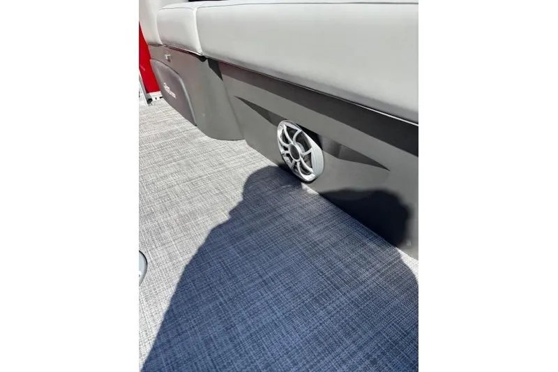 Slide: The Image of 2026 Sun Tracker Party Barge 22 RF DLX interior with speaker and seating detail. - 11