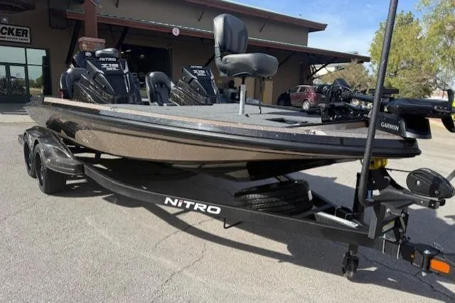 Slide: The Image of 2026 Nitro Z19 XL Pro boat on trailer, parked outdoors near a building. - 0