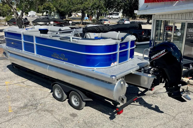 Slide: The Image of 2026 Sun Tracker Party Barge 22 DLX pontoon boat with Mercury engine on trailer. - 3
