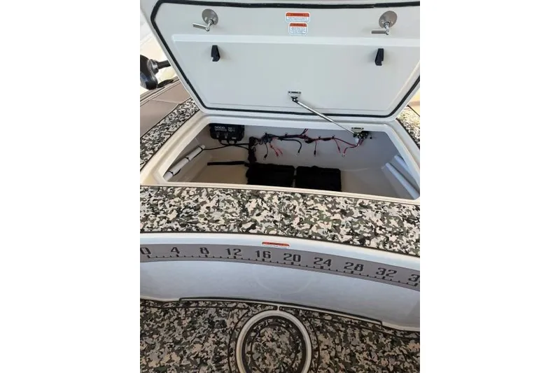 Slide: The Image of Open storage compartment of 2026 Mako 18 Pro Skiff Backwater Edition boat. - 11