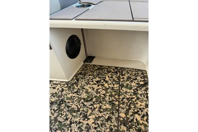 Slide: The Image of 2026 Mako 18 Pro Skiff Backwater Edition interior with camo flooring and speaker. - 13