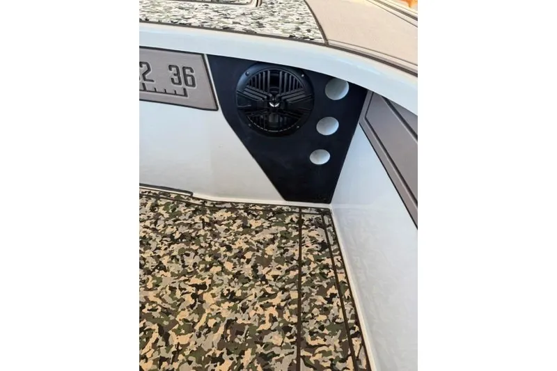 Slide: The Image of 2026 Mako 18 Pro Skiff Backwater Edition interior with camo flooring and speaker detail. - 15