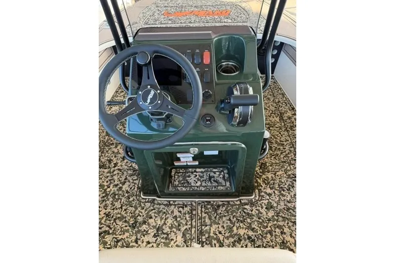 Slide: The Image of Steering console of 2026 Mako 18 Pro Skiff Backwater Edition with camo flooring. - 10