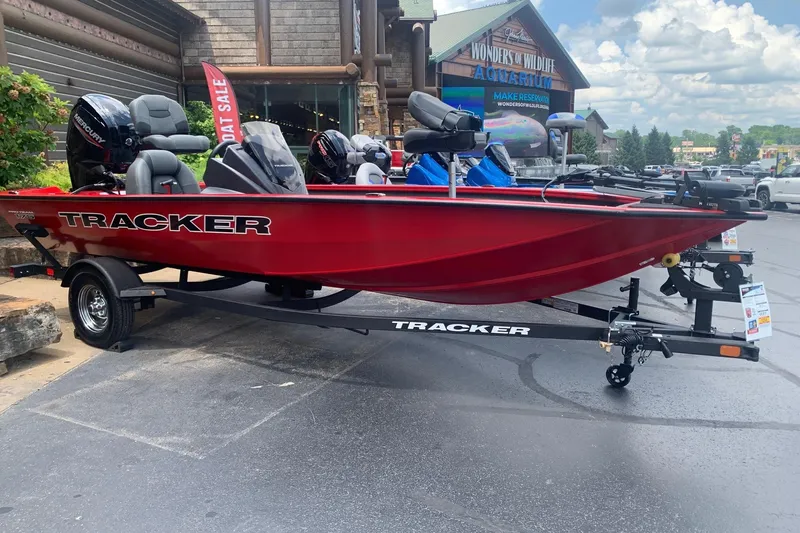 The Image of 2026 Tracker Pro Team 175 boat in vibrant red on display outside an aquarium. - 0