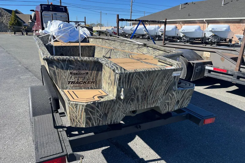 Slide: The Image of 2026 Tracker Grizzly 1650 T Prairie Wings Edition boat on trailer, camo design. - 31