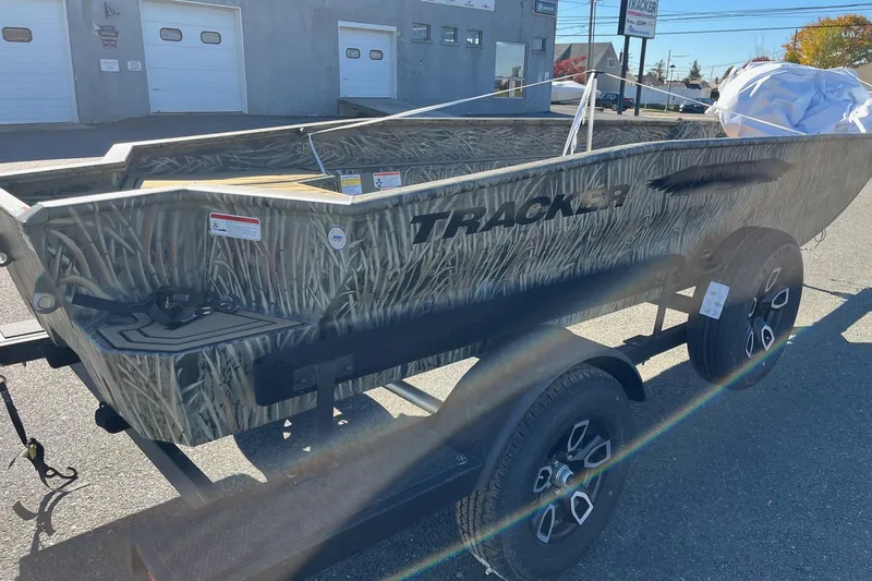 Slide: The Image of 2026 Tracker Grizzly 1650 T Prairie Wings Edition boat on trailer, camo design. - 32