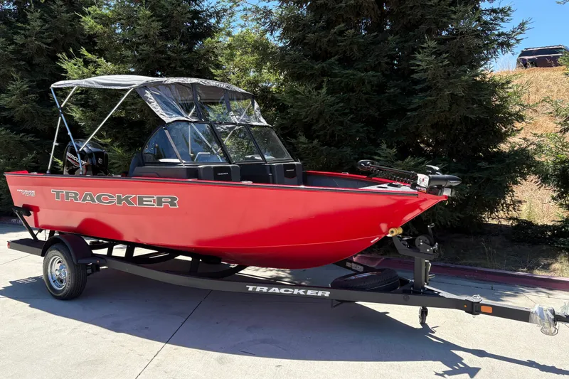 Slide: The Image of 2026 Tracker Pro Guide V-175 WT boat in vibrant red on a trailer. - 3