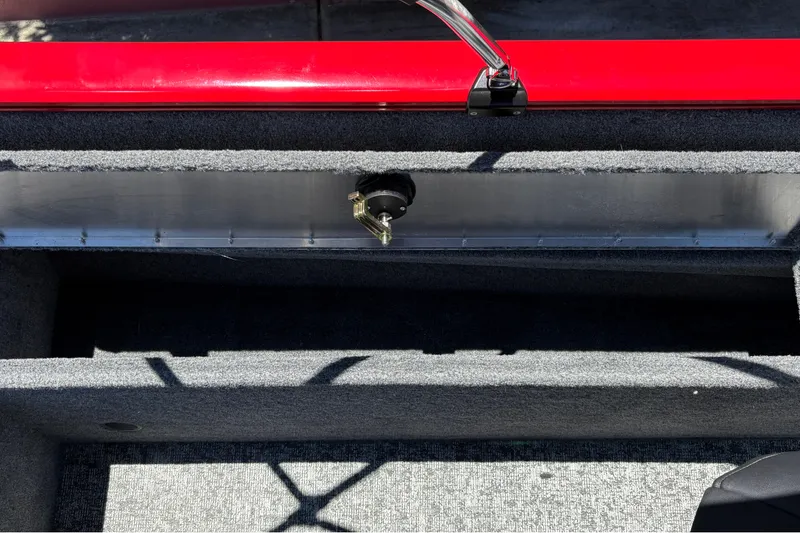 Slide: The Image of Interior view of 2026 Tracker Pro Guide V-175 WT boat, featuring storage compartment and red trim. - 23