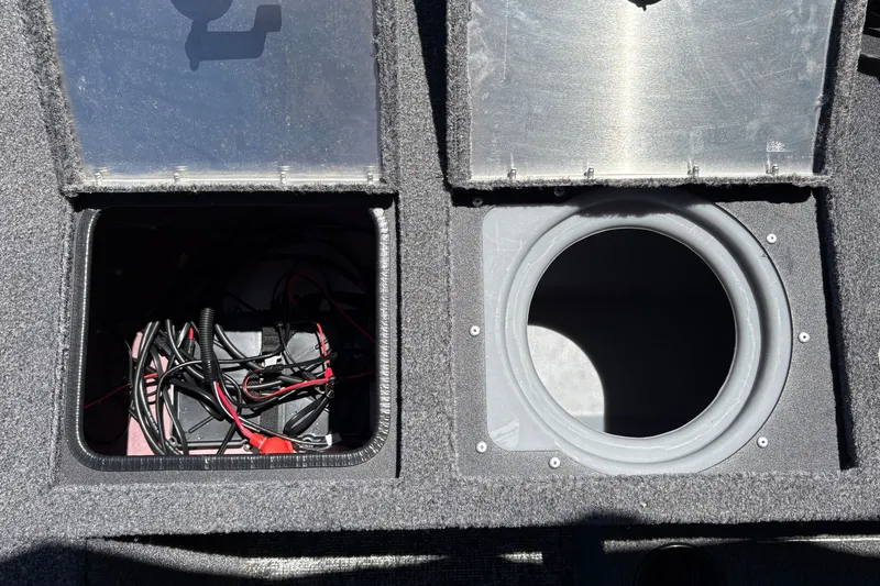 Slide: The Image of Open compartments in a 2026 Tracker Pro Guide V-175 WT boat, showing wiring and storage. - 30