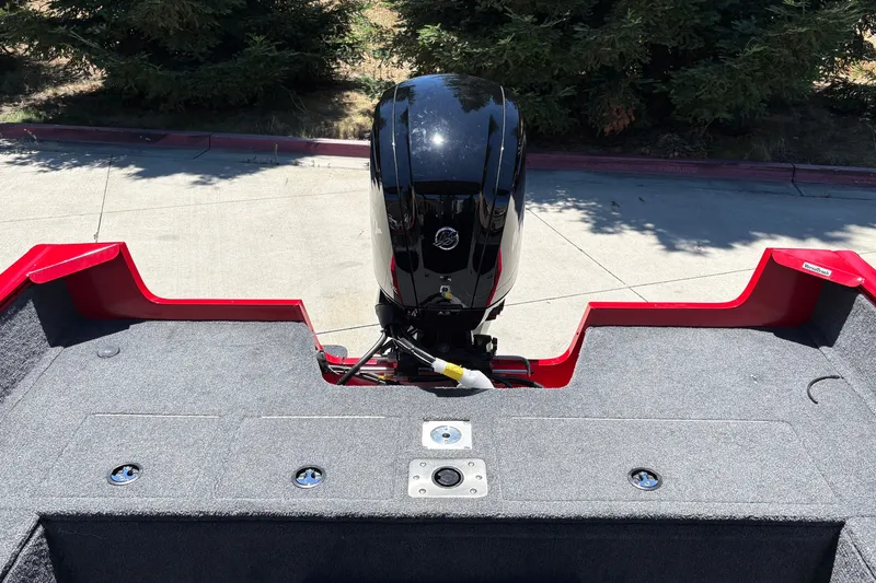 Slide: The Image of 2026 Tracker Pro Guide V-175 WT boat with outboard motor, red and gray interior. - 18