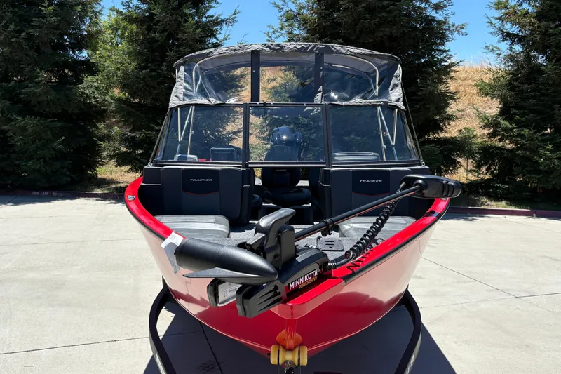 Slide: The Image of 2026 Tracker Pro Guide V-175 WT boat with Minn Kota motor, parked outdoors. - 11